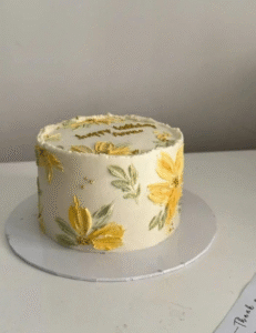  A cake adorned with vibrant yellow flowers, showcasing a festive and elegant design.<br />
